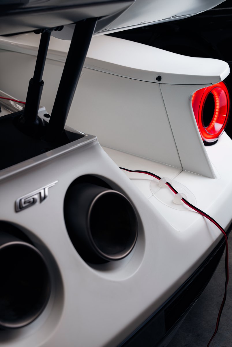 Ghost Guard next to the exhausts of a white car