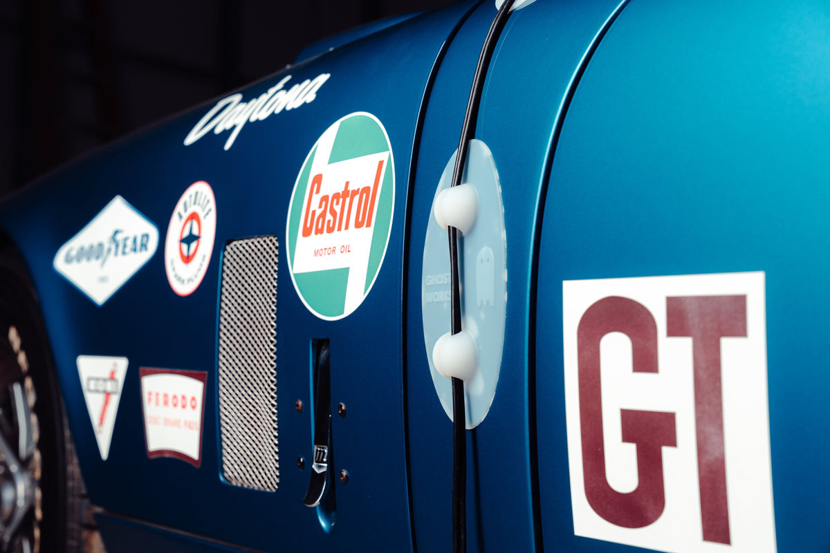 Ghost Guard on the side of a blue race car with vintage decals